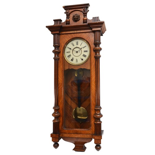 317 - A walnut veneered Vienna style wall clock, late 19th century, the cornice mounted with the head of a... 