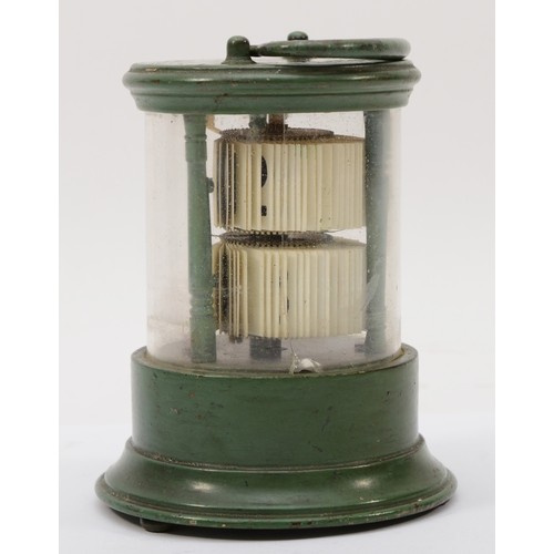 324 - A 20th century flip ticket clock, in a green painted tin and glass cylindrical and glass case, with ... 