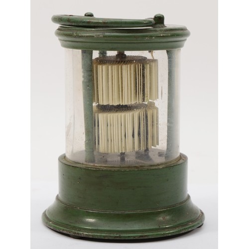 324 - A 20th century flip ticket clock, in a green painted tin and glass cylindrical and glass case, with ... 