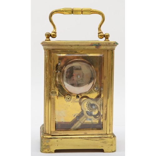 329 - A 20th century brass corniche cased hourly striking alarm carriage clock, the white dial with black ... 