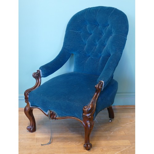 377 - A 19th century mahogany framed spoon button back open arm nursing chair, raised on carved cabriole s... 