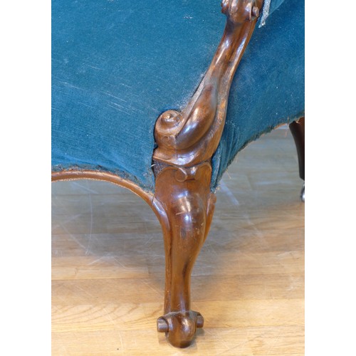 377 - A 19th century mahogany framed spoon button back open arm nursing chair, raised on carved cabriole s... 