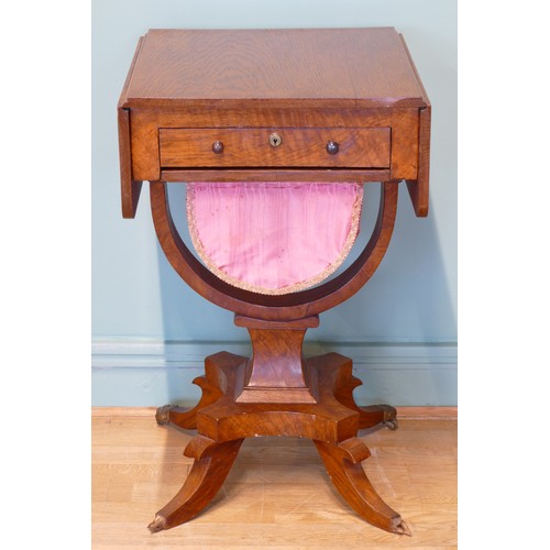 378 - An oak drop leaf sewing table, with two sets of drawers, raised on invert bow stretcher, standing on... 