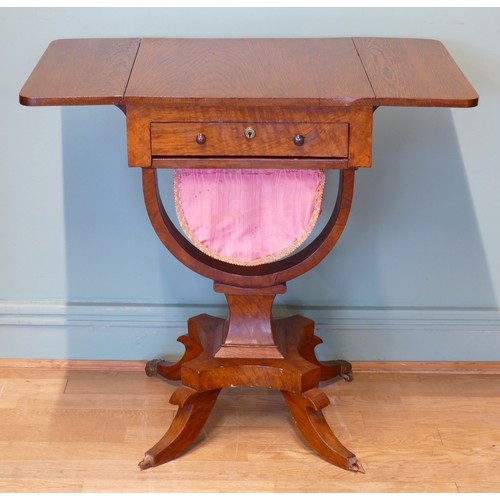 378 - An oak drop leaf sewing table, with two sets of drawers, raised on invert bow stretcher, standing on... 