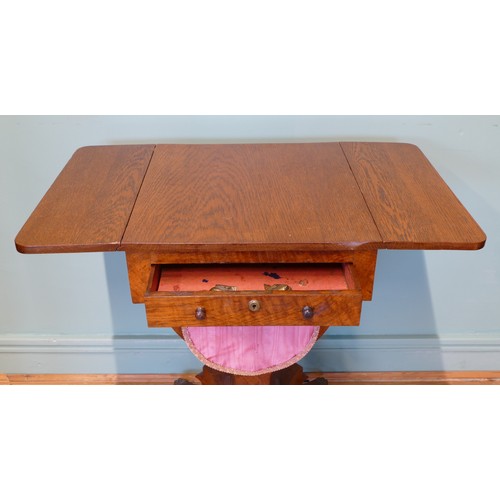 378 - An oak drop leaf sewing table, with two sets of drawers, raised on invert bow stretcher, standing on... 