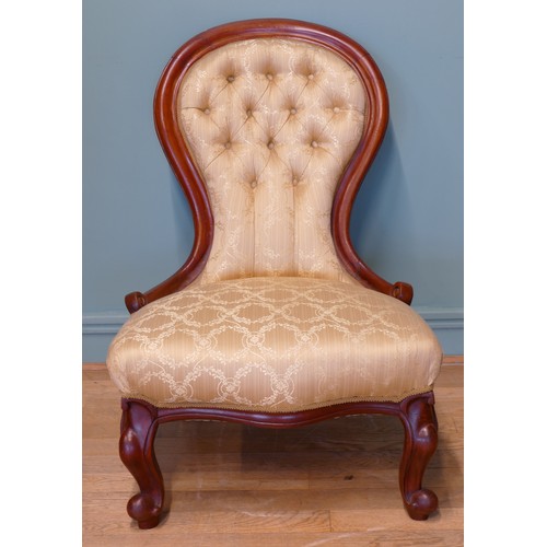 379 - A 19th century mahogany framed button spoon back low nursing chair, raised on carved cabriole suppor... 