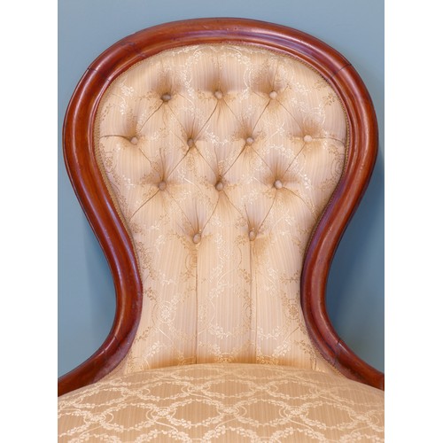 379 - A 19th century mahogany framed button spoon back low nursing chair, raised on carved cabriole suppor... 