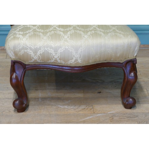 379 - A 19th century mahogany framed button spoon back low nursing chair, raised on carved cabriole suppor... 