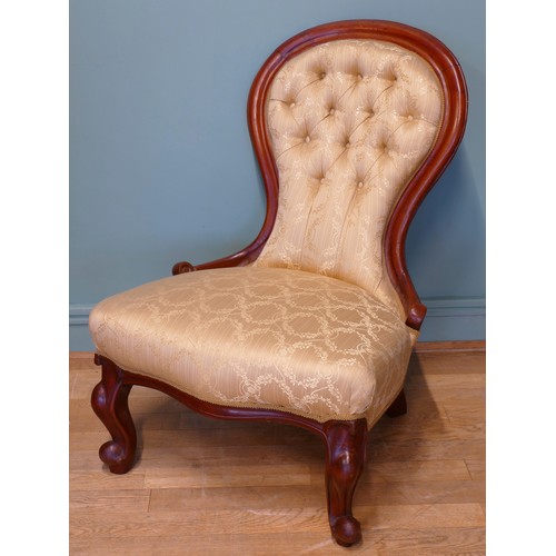 379 - A 19th century mahogany framed button spoon back low nursing chair, raised on carved cabriole suppor... 