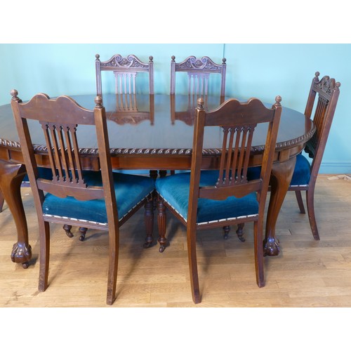 384 - An early 20th century mahogany wind out extending dining table with carved moulding, raised on cabri... 