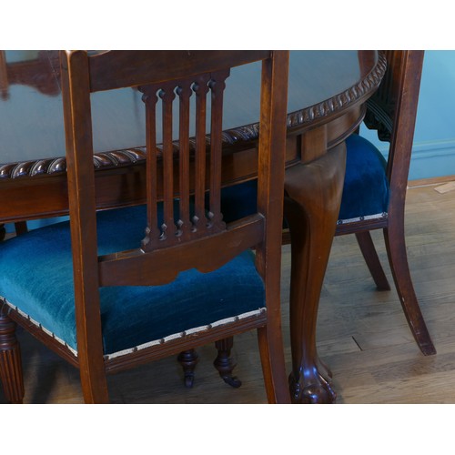 384 - An early 20th century mahogany wind out extending dining table with carved moulding, raised on cabri... 