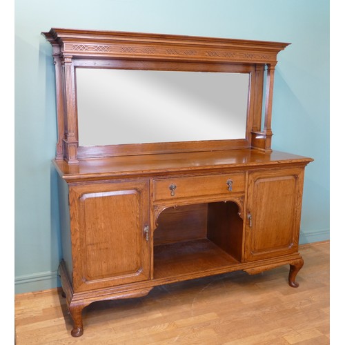 385 - An Edwardian oak mirror back sideboard, the blind fretwork frieze with geometric pattern with mirror... 