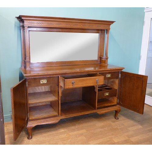 385 - An Edwardian oak mirror back sideboard, the blind fretwork frieze with geometric pattern with mirror... 