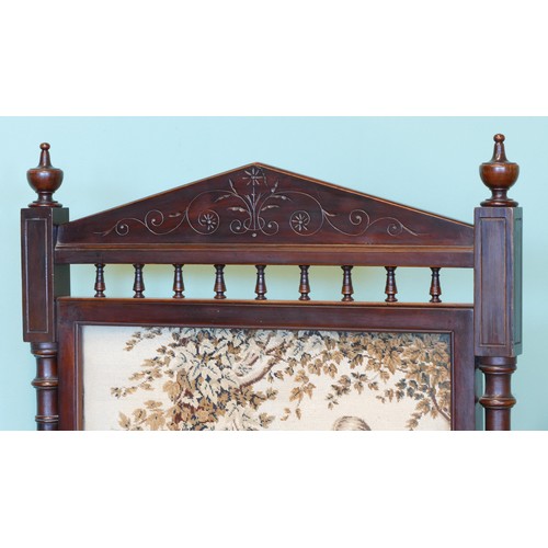 386 - An Edwardian carved mahogany framed embroidered fire screen, with twin reeded supports raised on out... 