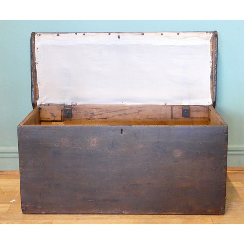 388 - A 19th/early 20th century stained pine tapering twin handled travelling trunk, the hinged lid openin... 