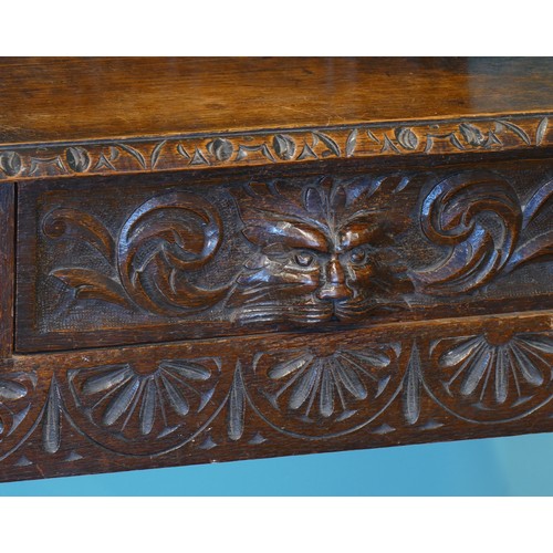 389 - A late 19th century heavily carved oak mirror back hallstand/coat stand, the frieze carved with the ... 