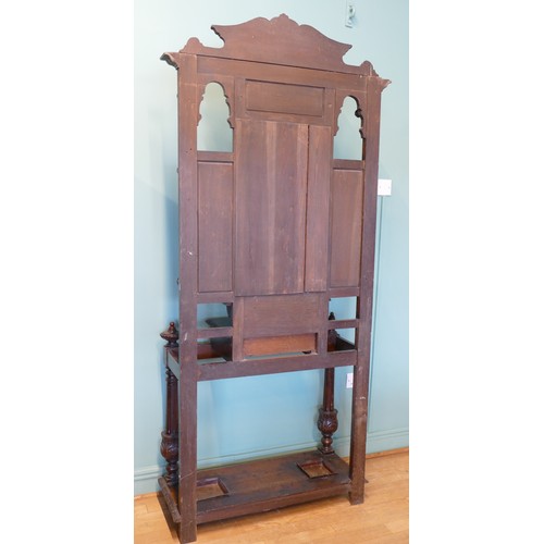 389 - A late 19th century heavily carved oak mirror back hallstand/coat stand, the frieze carved with the ... 