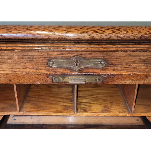 391 - An early 20th century oak tambour twin pedestal writing desk, opening to reveal fitted interior, eac... 