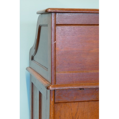 391 - An early 20th century oak tambour twin pedestal writing desk, opening to reveal fitted interior, eac... 