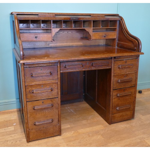 391 - An early 20th century oak tambour twin pedestal writing desk, opening to reveal fitted interior, eac... 