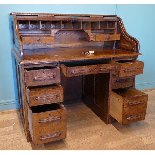 391 - An early 20th century oak tambour twin pedestal writing desk, opening to reveal fitted interior, eac... 