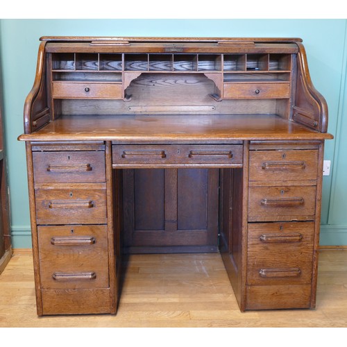 391 - An early 20th century oak tambour twin pedestal writing desk, opening to reveal fitted interior, eac... 