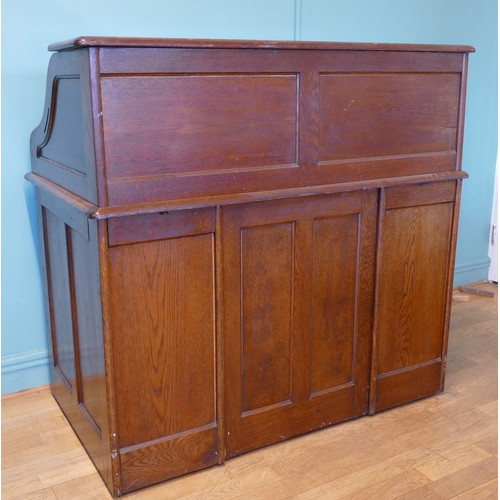 391 - An early 20th century oak tambour twin pedestal writing desk, opening to reveal fitted interior, eac... 