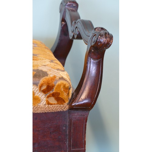 392 - An early 20th century mahogany duet piano stool with shaped and carved supports, upholstered box sea... 