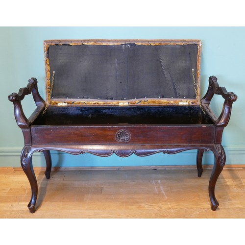 392 - An early 20th century mahogany duet piano stool with shaped and carved supports, upholstered box sea... 