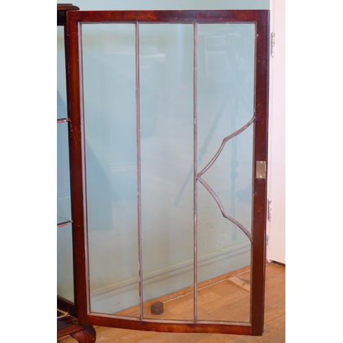 393 - An Edwardian mahogany display cabinet, having two glazed doors of serpentine form opening to reveal ... 