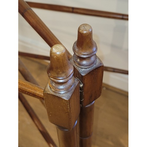 396 - A 19th century mahogany bamboo effect two fold floor standing clothes horse, raised on turned feet, ... 