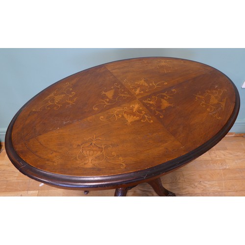 397 - A small Victorian mahogany oval table with floral inlay, on a carved quadripartite birdcage base wit... 