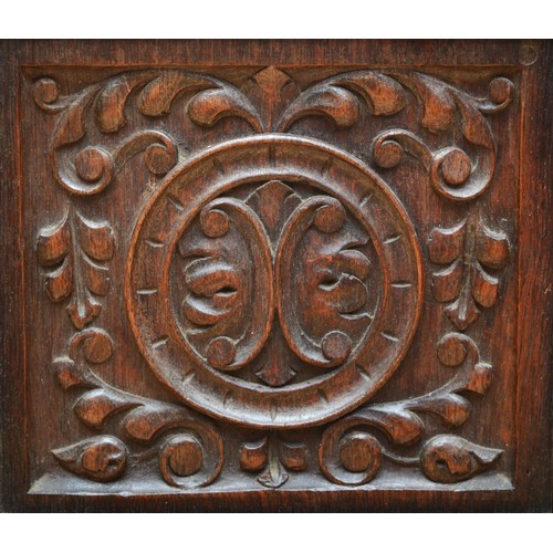 398 - A 19th century heavily carved oak cabinet, with two drawers above three cupboard doors, the central ... 