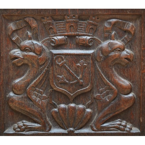 398 - A 19th century heavily carved oak cabinet, with two drawers above three cupboard doors, the central ... 