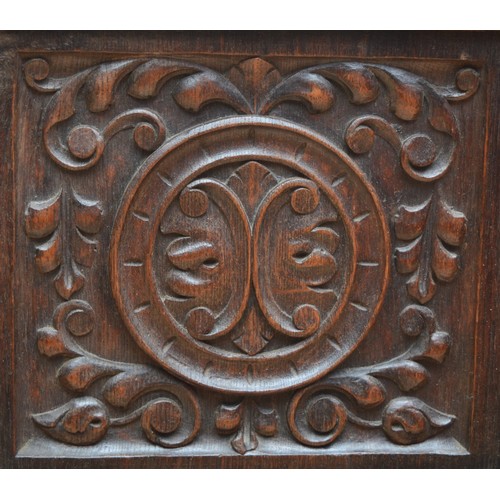 398 - A 19th century heavily carved oak cabinet, with two drawers above three cupboard doors, the central ... 