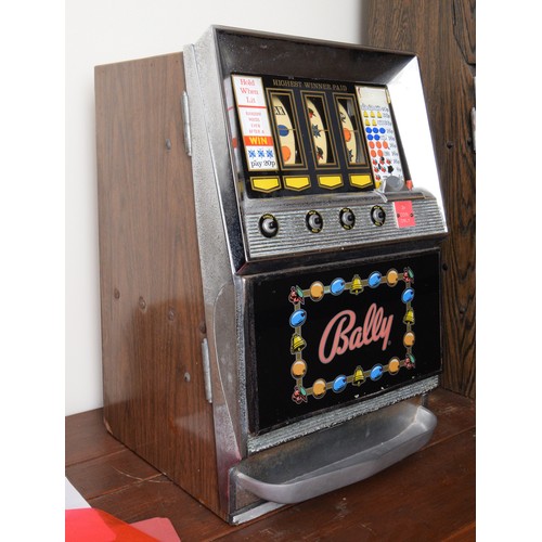 400 - Bally, an electromechanical three reel and hold slot machine, c.1965/70, 48 x 46 x 67cm, 2p play.
Pr... 