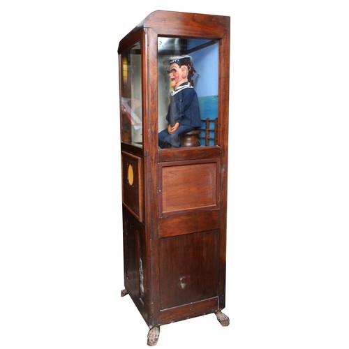 424 - Laughing sailor, HMS Happy, by Modern Enterprises, stained oak cabinet, raised on cast metal feet, 5... 