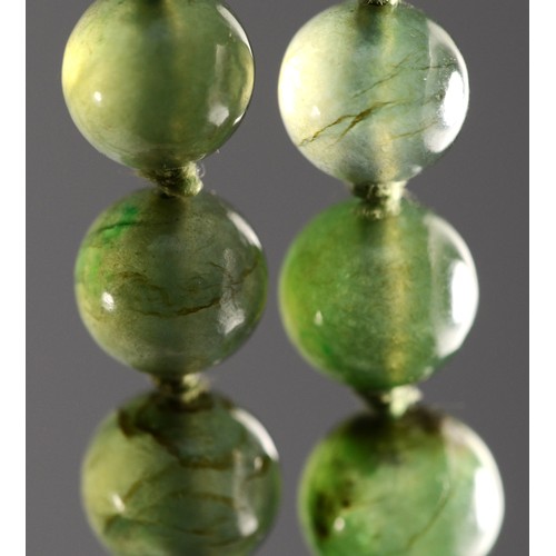A gold clasped green hard stone graduating beaded necklace, 79cm.