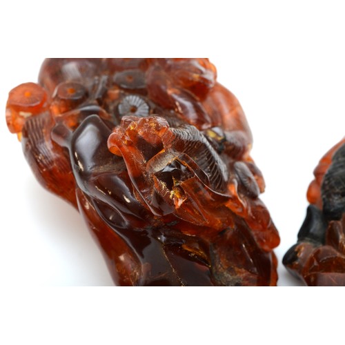 281 - Three Chinese 20th century carved amber figures comprising of two fisherman, 5.3cm high, a standing ... 