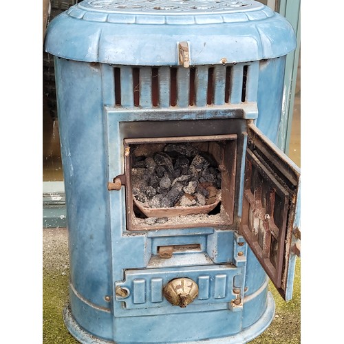 64 - A Victorian style blue painted cast iron fire/heater with brass chimney, 65cm high.