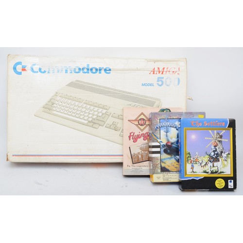 99 - A 1980s Amiga 500 computer/games console by C-Commodore, boxed with AC leads, adapter and manuals, t... 