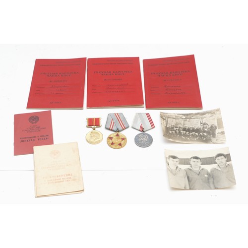 518 - A collection of Soviet Russian medals and paperwork, to include membership book, 100th anniversary o... 