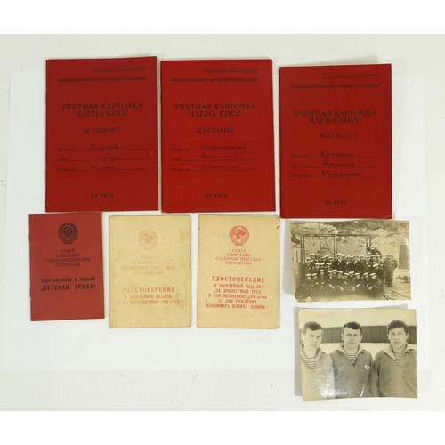 518 - A collection of Soviet Russian medals and paperwork, to include membership book, 100th anniversary o... 