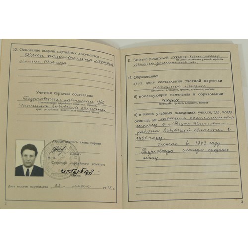 518 - A collection of Soviet Russian medals and paperwork, to include membership book, 100th anniversary o... 