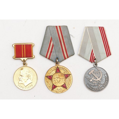 518 - A collection of Soviet Russian medals and paperwork, to include membership book, 100th anniversary o... 