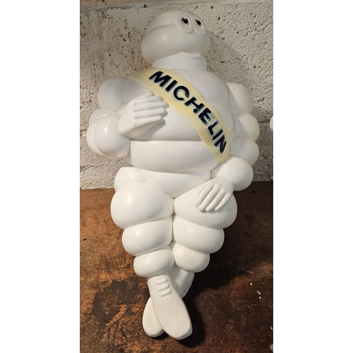 140 - A Bibendum or Michelin Man plastic seated lamp, lacking lighting, 50cm and a standing example, 31cm ... 