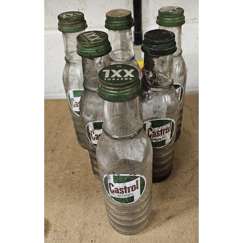 175 - A set of six Castrol glass one pint bottles, all with caps