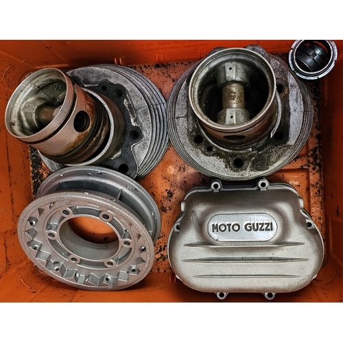 358 - A collection of Moto Guzzi 750 spares, including a NOS starter motor, cylinder heads, cam covers and... 