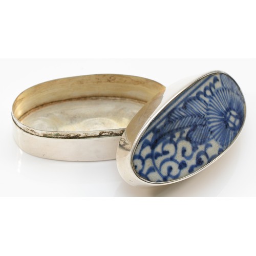 58 - A Siam sterling silver oval pot, with ceramic blue and white glazed lid, 6.5 x 3 x 3.3cm.