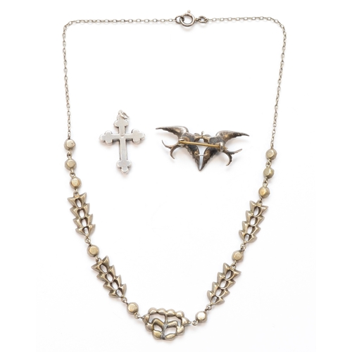 201 - A 900 silver swallow brooch set with rhinestones, 41 x 18mm, a silver paste stone cross and a paste ... 